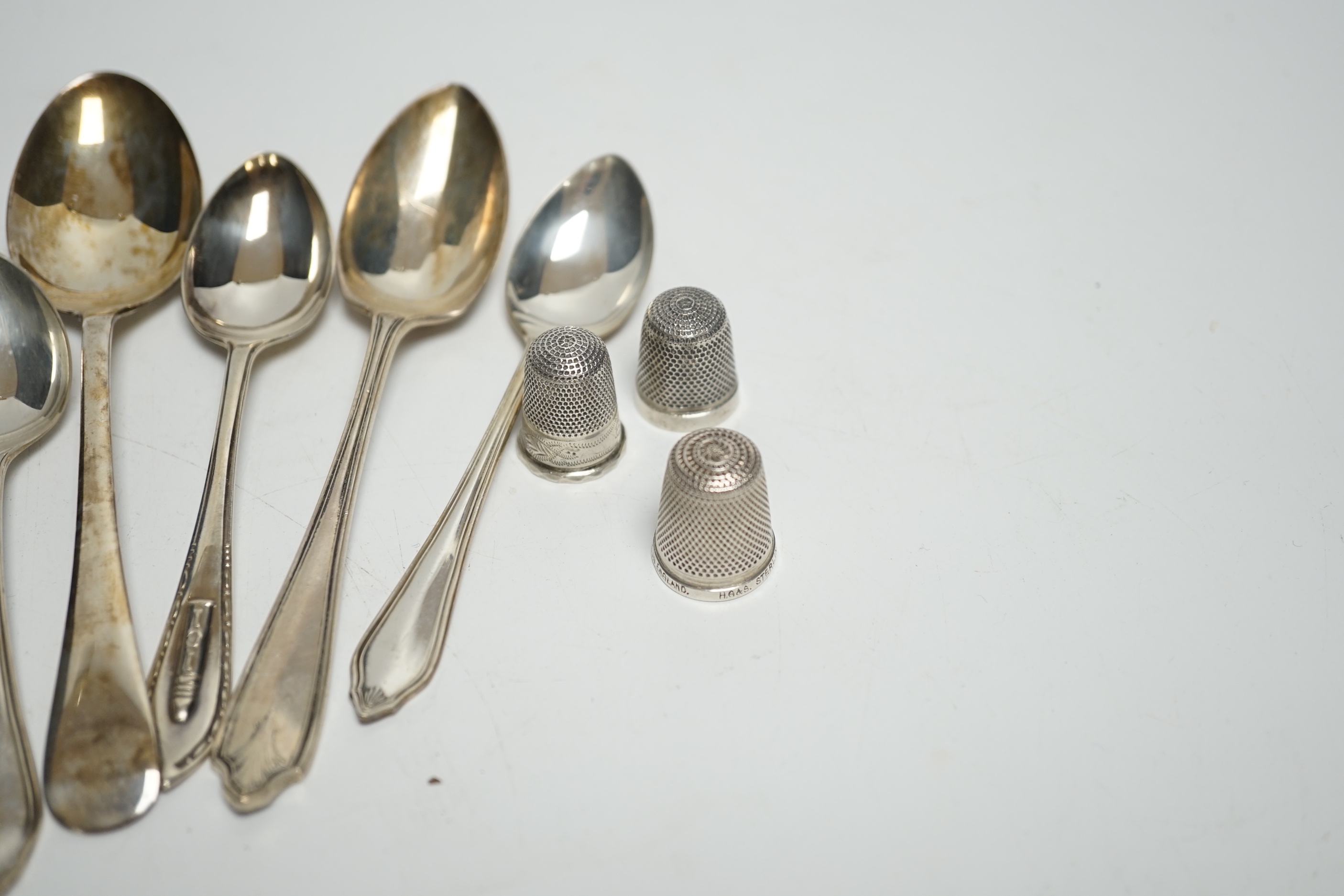 A small quantity of silver condiments and teaspoons, three silver thimbles and a sterling thimble.